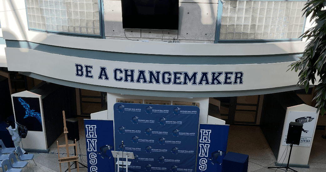 School atrium wall decal reading "Be a Changemaker"